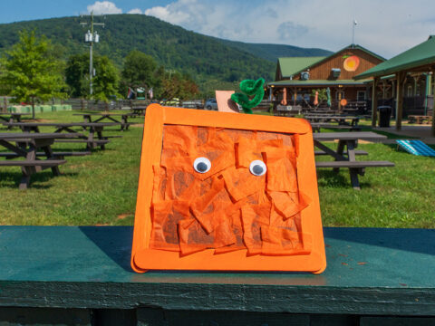 A square pumpkin craft with googly eyes